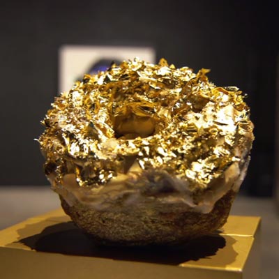 A bumpy gold foil covered donut